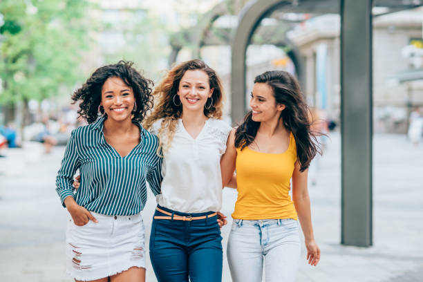 Three young women walking and laughing