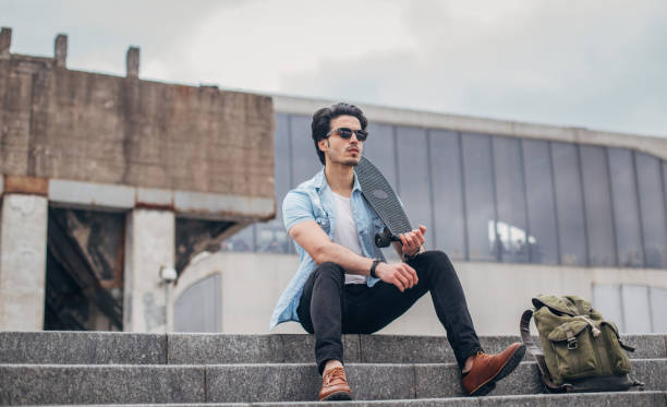 istock Fashionable guy with skateboard 1170733035