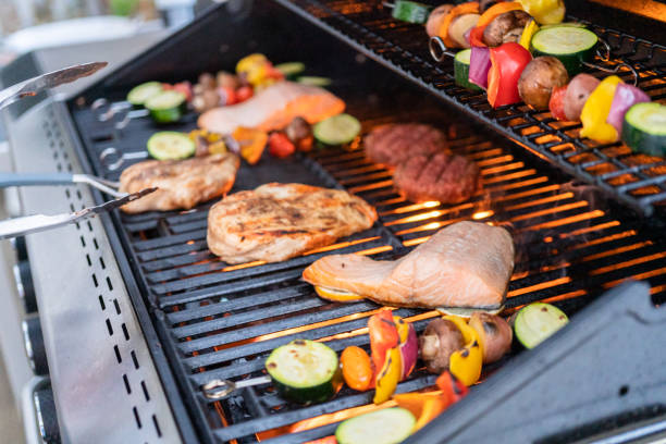 istock Grilling an Atlantic salmon, chicken breast, vegetable skewers 1170733094