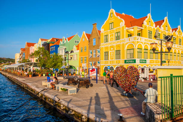 Tourists on the beautiful promenade of Punda in Willemstad, the capital city of Curaçao, an island in the southern Caribbean Sea.