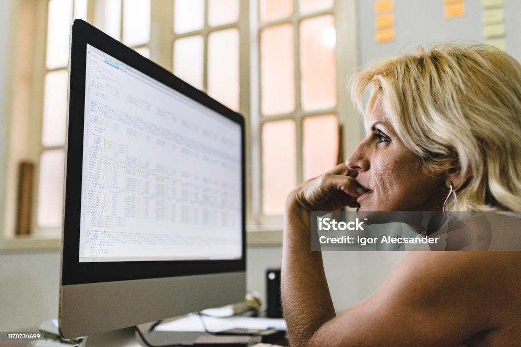 Woman working on programming codes Working At Home Stock Photo