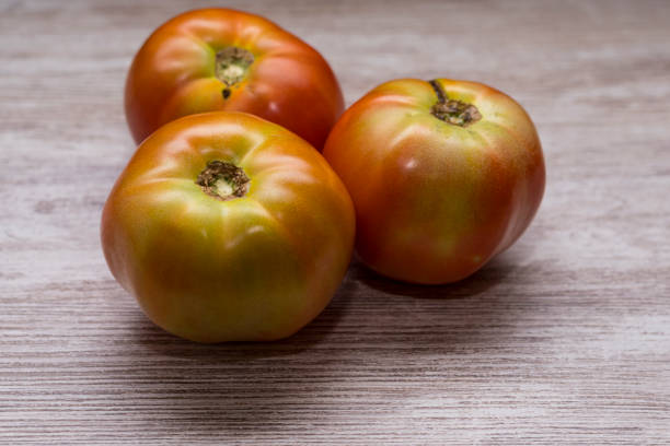 Organic tomatoes on a wooden table