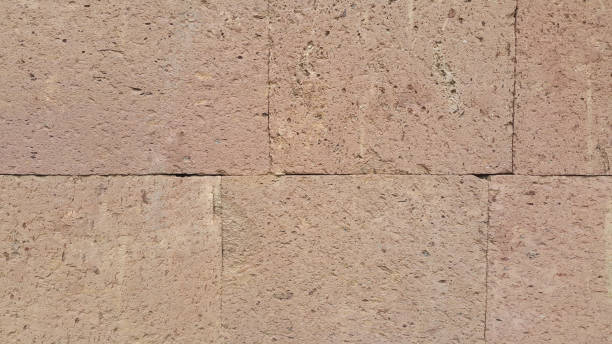 istock red tuff wall, fence, stones laid and fixed as facade 1170735785