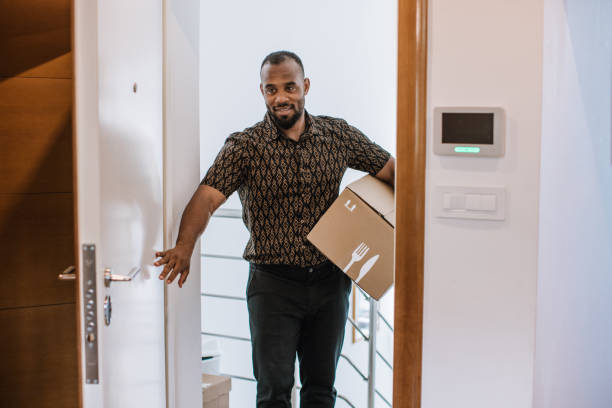 istock Latin Man Opening Parcel With Meal Kit 1170736090