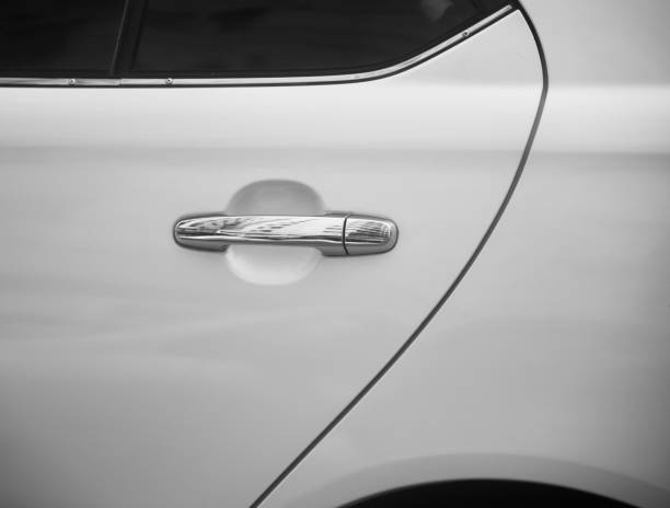 istock Metallic door knobs of a white car unique photo 1170736838