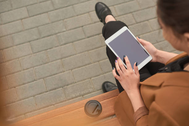 istock Woman hands with tablet working outdoor 1170739388