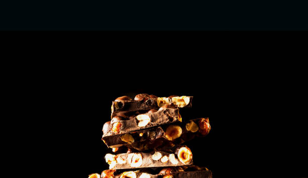 istock Chocolate pieces with almonds on dark background. Copy space 1170740871