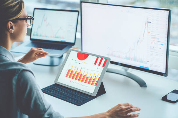 rear view of woman financial specialist studying theory and practice blockchain technology. female broker sitting front computer with graphs statistics of stock exchange. earnings on raising quotes - internet success household equipment horizontal imagens e fotografias de stock