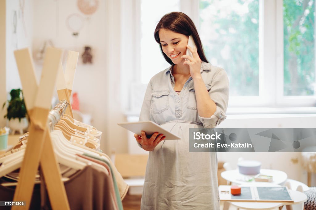 Young woman in a shopping store Baby Shop Stock Photo