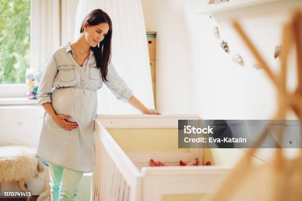 Young Woman In A Shopping Store Stock Photo - Download Image Now - Pregnant, Crib, Mother