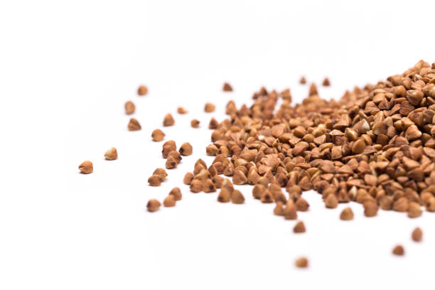 istock buckwheat grain isolated on white background close up with copy space for your text. Top view 1170741575