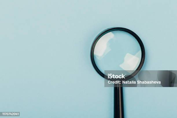Small Magnifying Glass On Pastel Blue Background Search Symbol Stock Photo  - Download Image Now - iStock