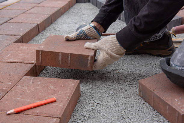Installing paver bricks for patio in backyard. A workman's gloved hands use a hammer to place stone pavers. Toronto,Canada. yard measurement stock pictures, royalty-free photos & images