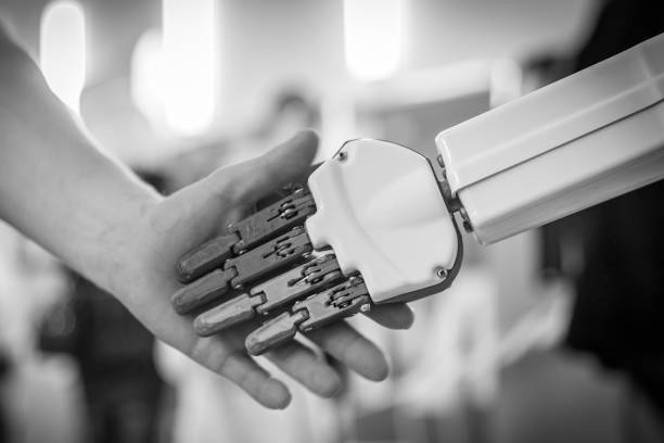 istock close up of man shaking hands with a robot 1170742406