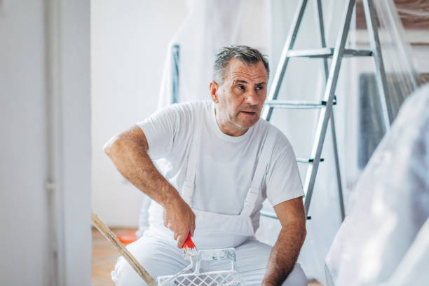 istock Senior man painting walls 1170742647