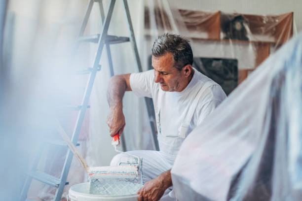 istock Senior worker painting walls 1170744005