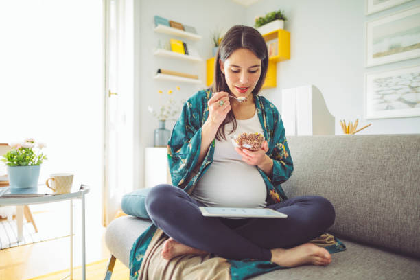 having breakfast at home - eating women breakfast cereal imagens e fotografias de stock