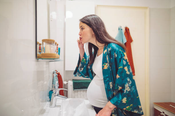 istock At home - young woman brushing her teeth 1170744438