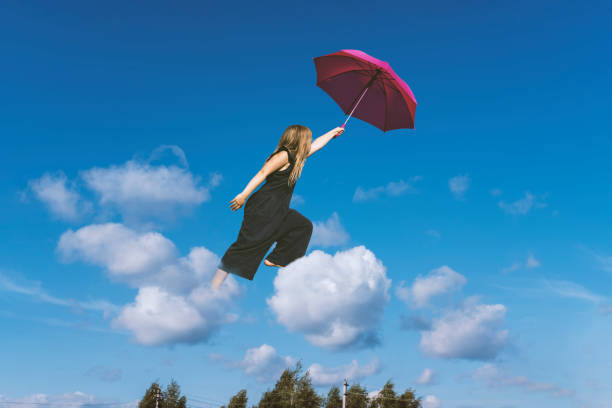 istock Cute girl jumping funny in clouds 1170747550