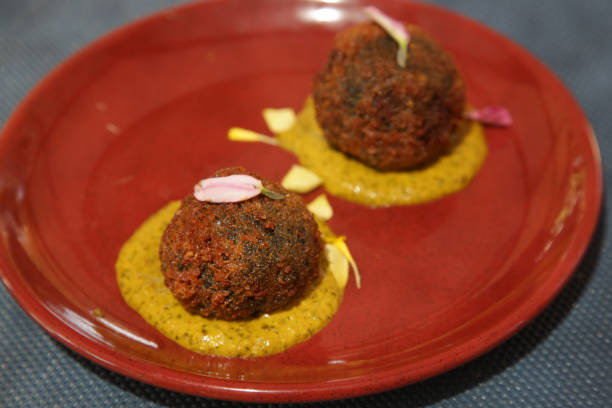 istock Squid ink Arancini, breadcrumb coated rice balls with squid ink served on the ceramic red plate 1170749079