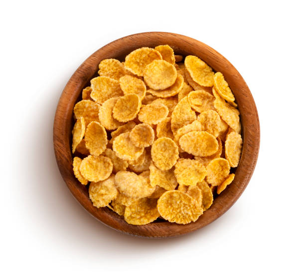 istock Corn flakes in wooden bowl isolated on white background 1170750348