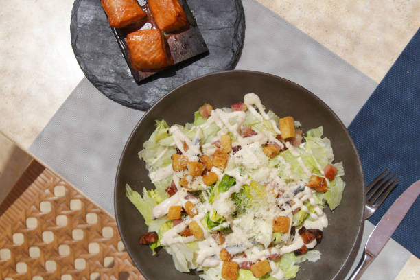 A Caesar salad with grilled tuna pieces served on the restaurant table, tasty and healthy summer meal A Caesar salad with grilled tuna pieces served on the restaurant table, tasty and healthy summer meal caesar salad food salad tuna stock pictures, royalty-free photos & images