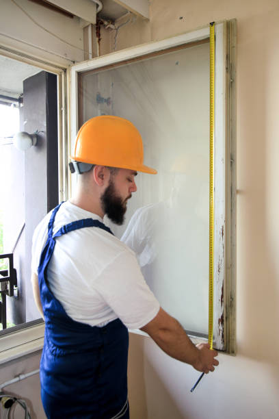 istock Construction worker and handyman is working on renovation of apartment. Builder is measuring window using measure tape at construction site. House renovation concept. Construction and service tools. 1170750937