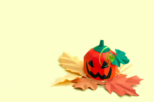 istock Paper Jack-o-lantern with autumn leaves 1170754473