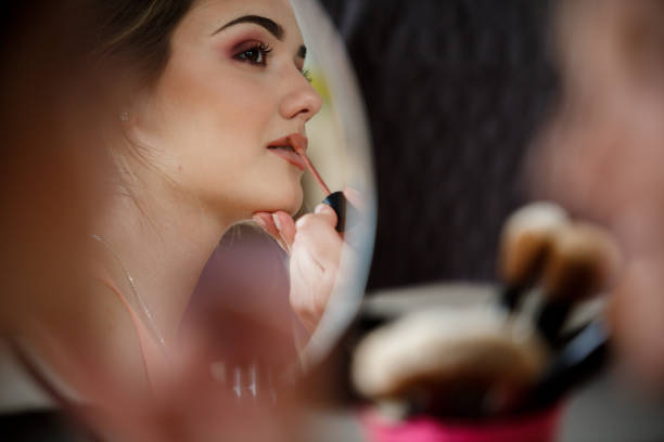 istock Beautiful young woman enjoying while getting her make up done 1170755446