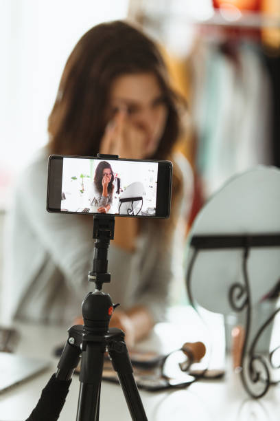 istock Young female vlogger doing her make up on live stream 1170756614