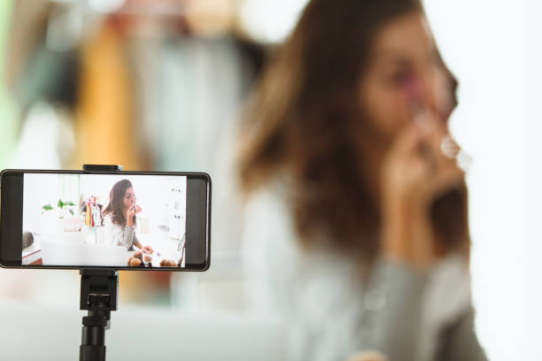 istock Young woman concentrating while doing her make up 1170756637