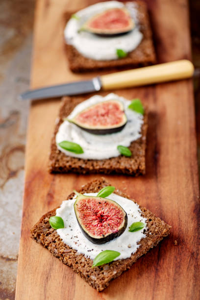 istock Fresh figs with ricotta cheese, fresh basil on rye bread, overhead view. 1170756958