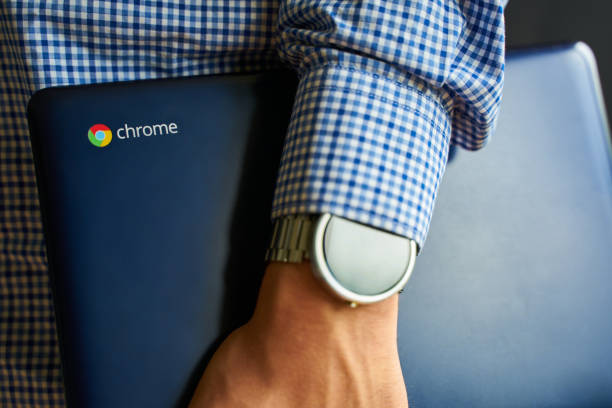 Asus Chromebook. Bishkek, Kyrgyzstan - June 6, 2019: Asus Chromebook in man's hand with watch on it. kyrgyzstan photos stock pictures, royalty-free photos & images