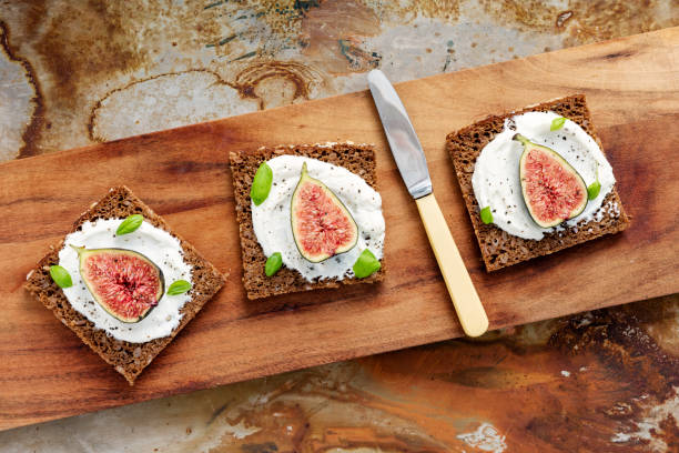 istock Fresh figs with ricotta cheese, fresh basil on rye bread, overhead view. 1170757803