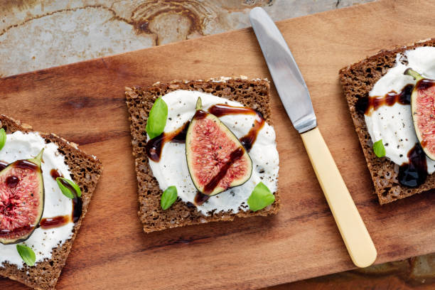 istock Fresh figs, ricotta cheese, fresh basil on rye bread with balsmic vinegar overhead view. 1170757853