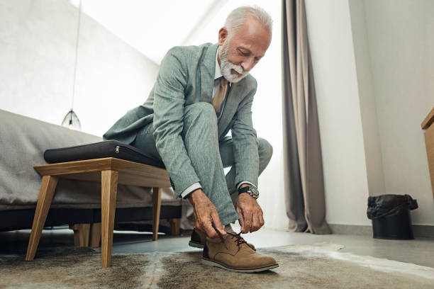 istock Mature businessman tying shoelaces 1170759179