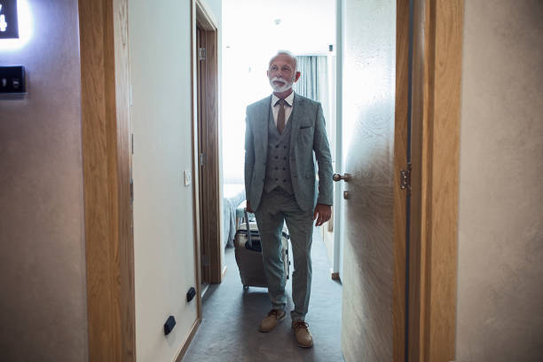 istock Senior businessman entering hotel lobby 1170759202