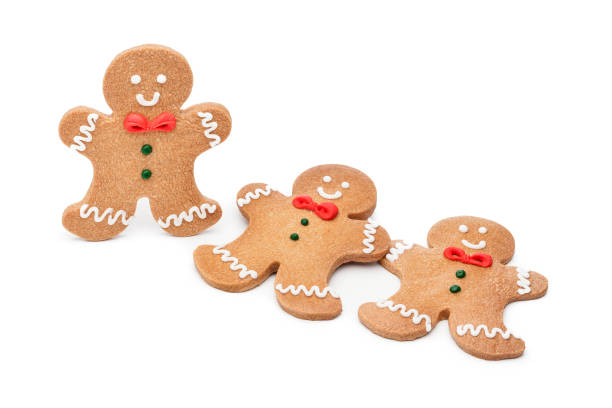 Three gingerbread cookies isolated on white background. Copy space available for text and/or logo. Predominant colors are brown and white. High key DSRL studio photo taken with Canon EOS 5D Mk II and Canon EF 100mm f/2.8L Macro IS USM.