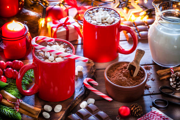 istock Two homemade hot chocolate mugs with marshmallows and candy canes on Christmas table 1170760356