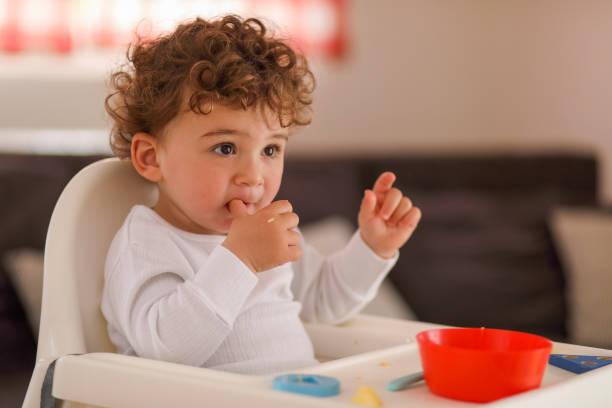 istock Baby boy eating on his own 1170764266
