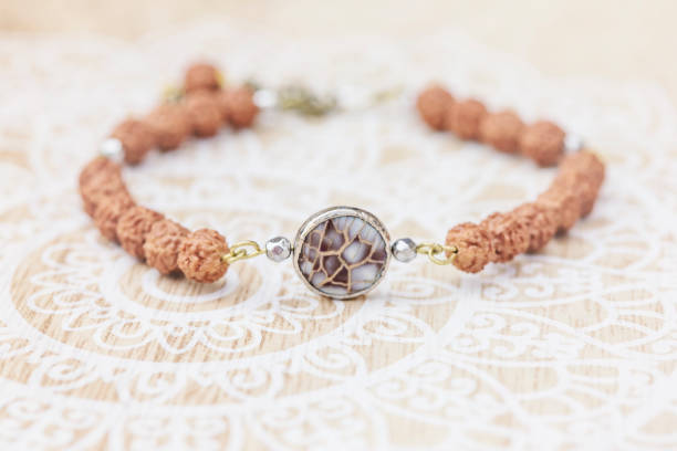Mother pearl natural bead rudraksha seed bracelet on decorative background