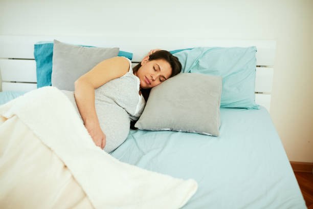 istock Pregnant woman sleeping. 1170766606