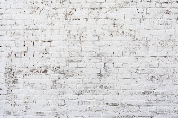 Empty Old Brick Wall Texture. Painted Distressed Wall Surface. Grungy Wide Brickwall. Shabby Building Facade With Damaged Plaster. stock photo