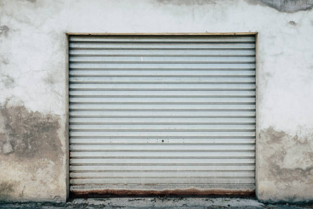 Old House with garage door for a background, isolated steel door, or storage room