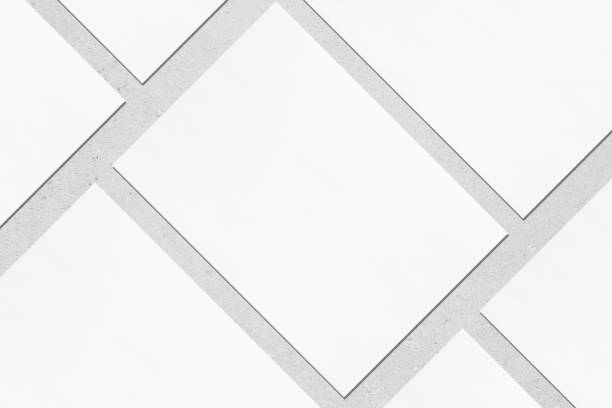 close up de mockups brancos vazios do poster do retângulo que encontram-se diagonalmente no fundo concreto cinzento - diagonally - fotografias e filmes do acervo