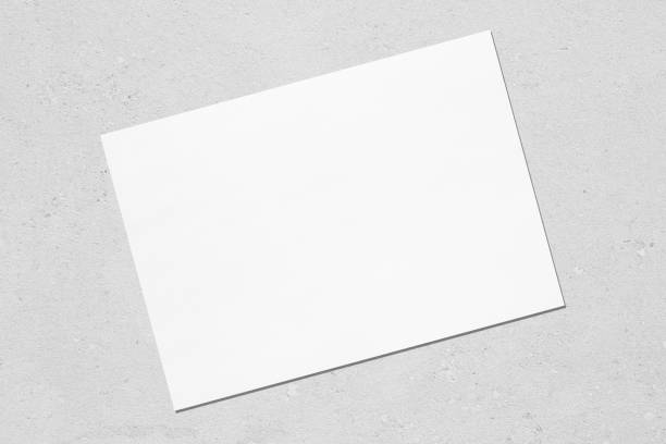 istock Empty white horizontal rectangle poster mockup lying diagonally on grey concrete background 1170767992