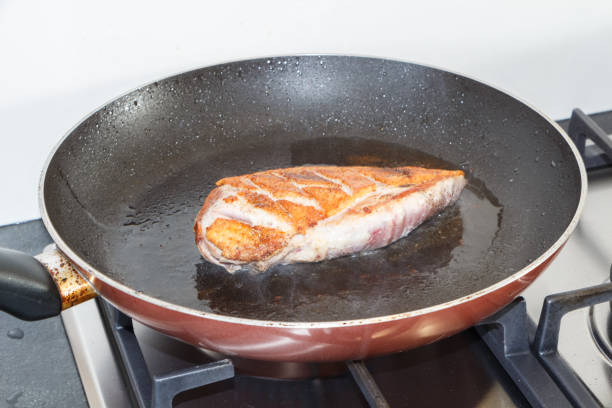 Duck breast grilling in a frying pan
