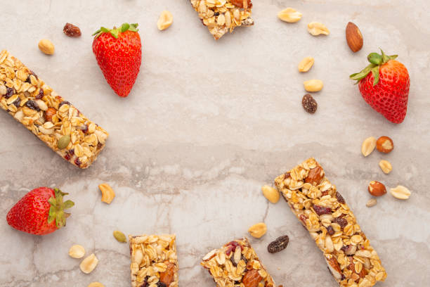 istock granola bars with nuts and strawberries on a light background with space for design, horizontal photo, diet, proper nutrition 1170771529