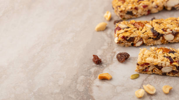 istock granola bars with nuts on a light background with space for design, horizontal photo, diet, proper nutrition 1170773354