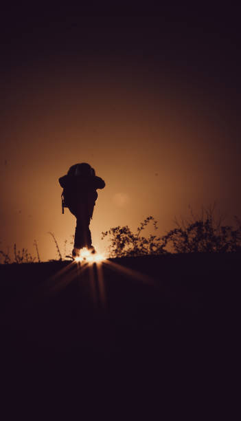 istock Longboarder silhouetted in sunset stock photo 1170775385